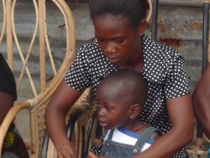 Mother weaving with child in Sierra Leone