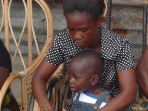 Mother weaving with child in Sierra Leone