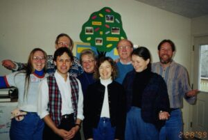 Eight people pose for the camera
