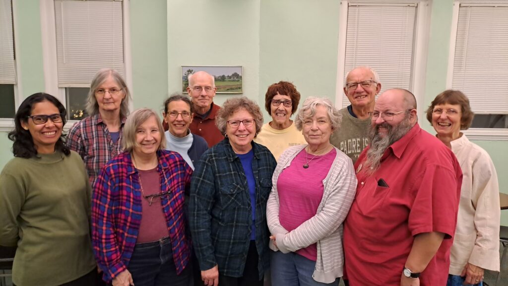 Two rows of people stand together