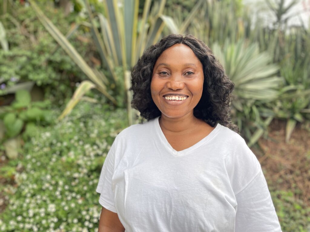 Sibella stands in front of some greenery