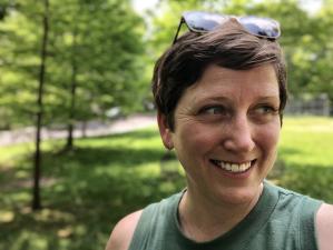 Beirne stands in front of greenery