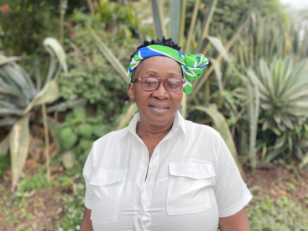 Sallian stands in front of some greenery