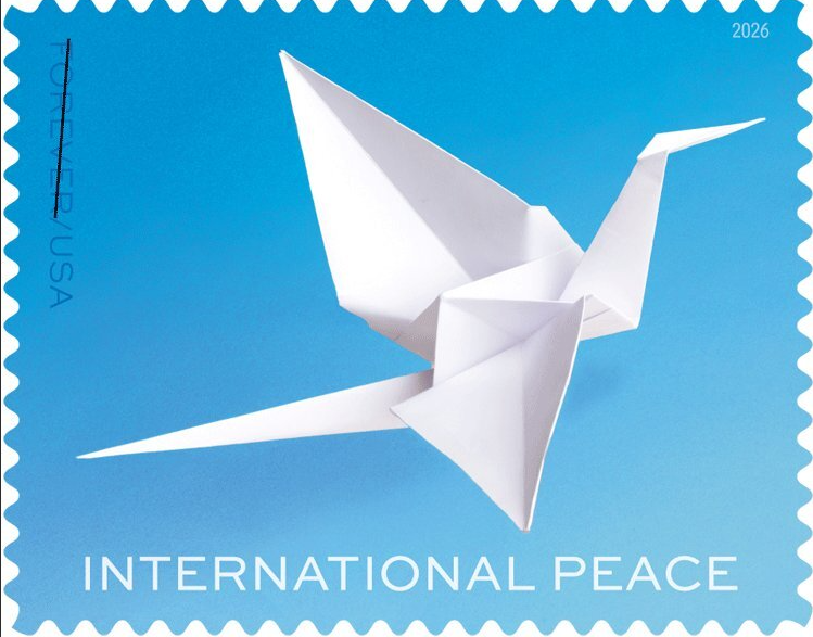 A picture of the international peace forever stamp, this includes a white paper crane on a blue background.